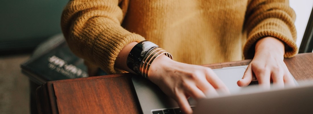 Woman typing on laptop.