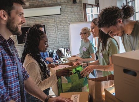 Group of people sat in a room watching a man present stood up