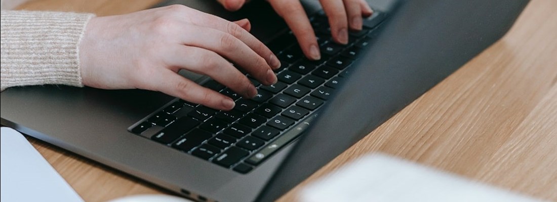 Hands typing on a keyboard.
