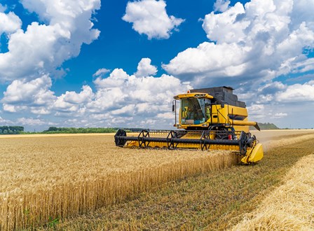 Group of people sat in a room watching a man present stood up